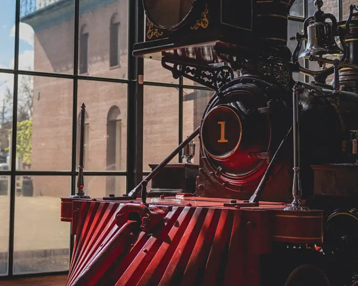 a photo of the front of an old steam locomotive in a museum