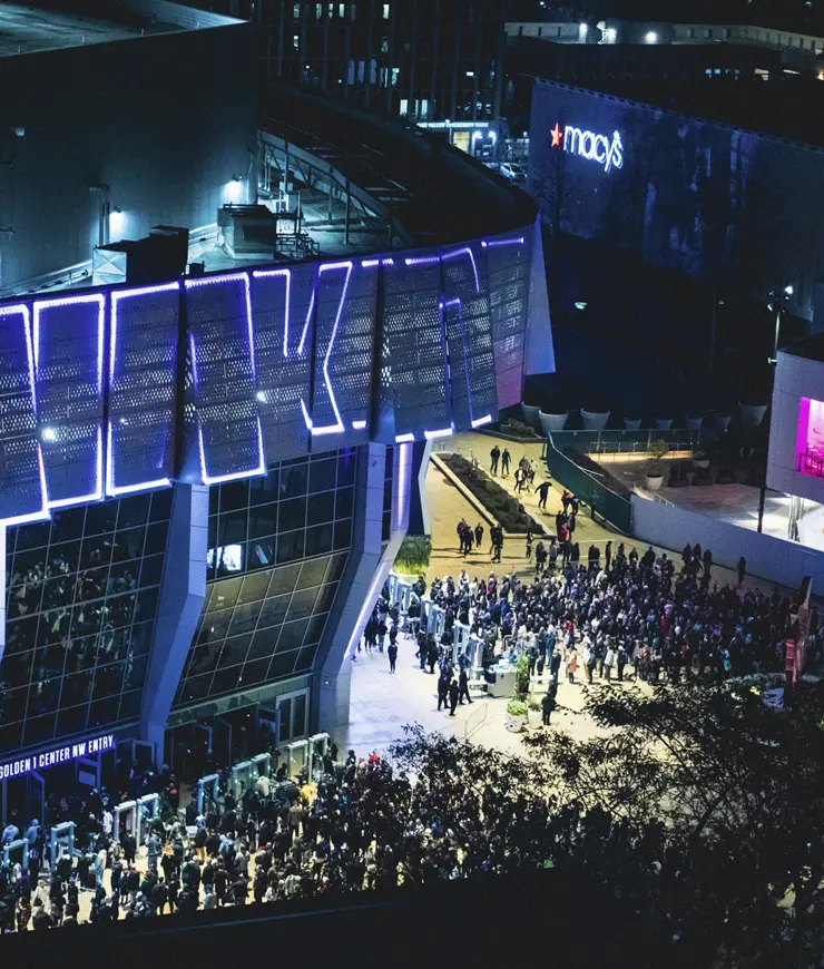 an aerial photo above the Golden One Center surrounded by crowds of people