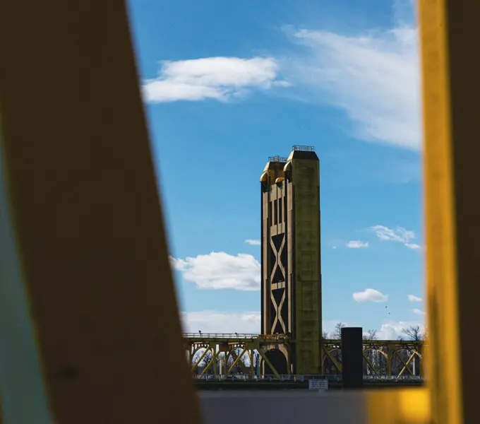 a photo of the Tower Bridge framed by steel beams