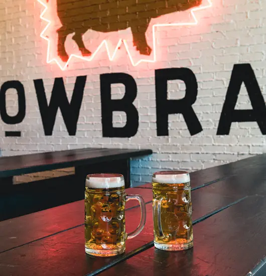 a photo of two steins of beers sitting on a table