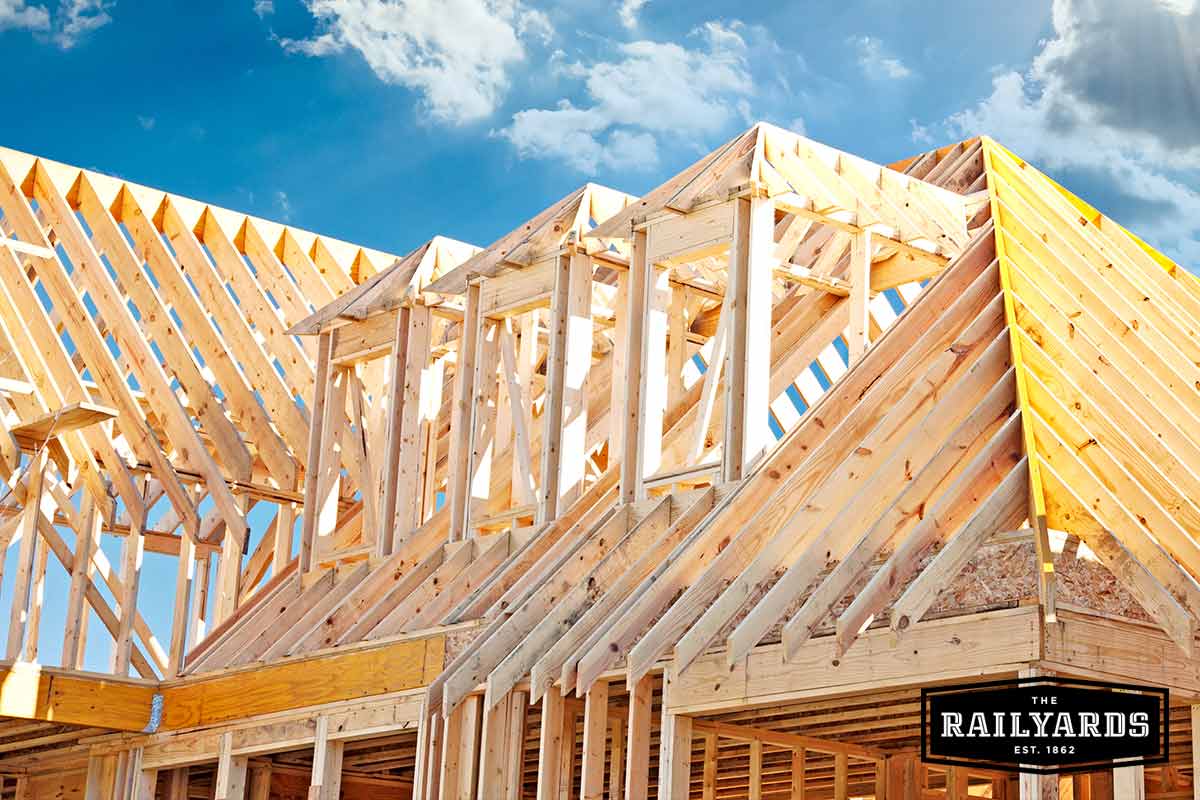 Sun shines down on the framework of a residential home being constructed.