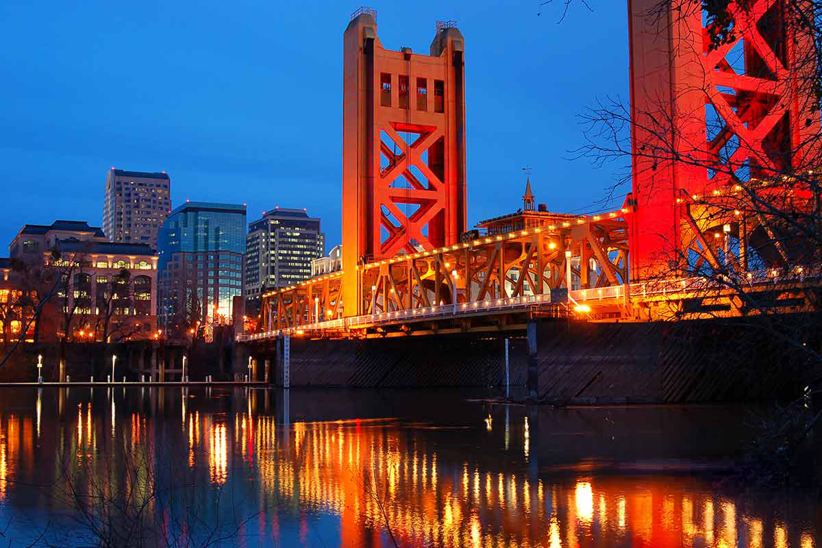 Sacramento’s tower bridge lit up at sunset.