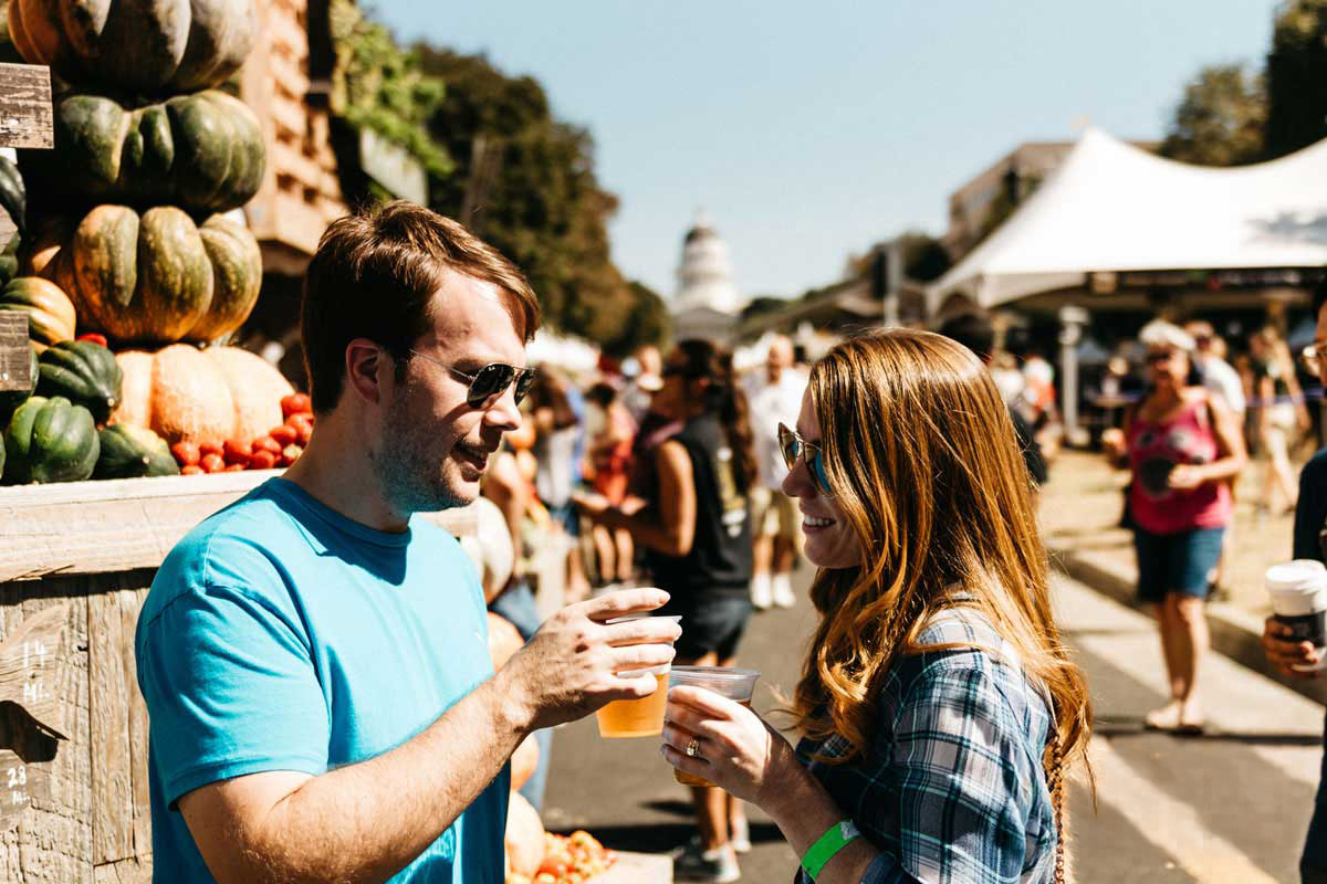 An image of a man and a woman at one of Sacramento's farm to fork events.
