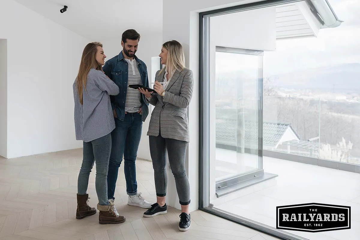 Couple discussing apartment with agent.